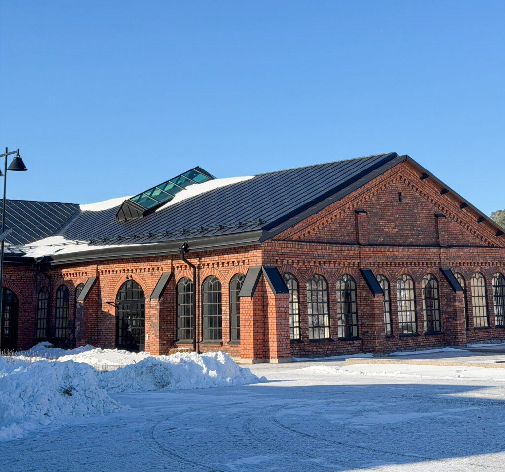 Exteriörbild av Filfabrikens tegelfasad och snö på marken.